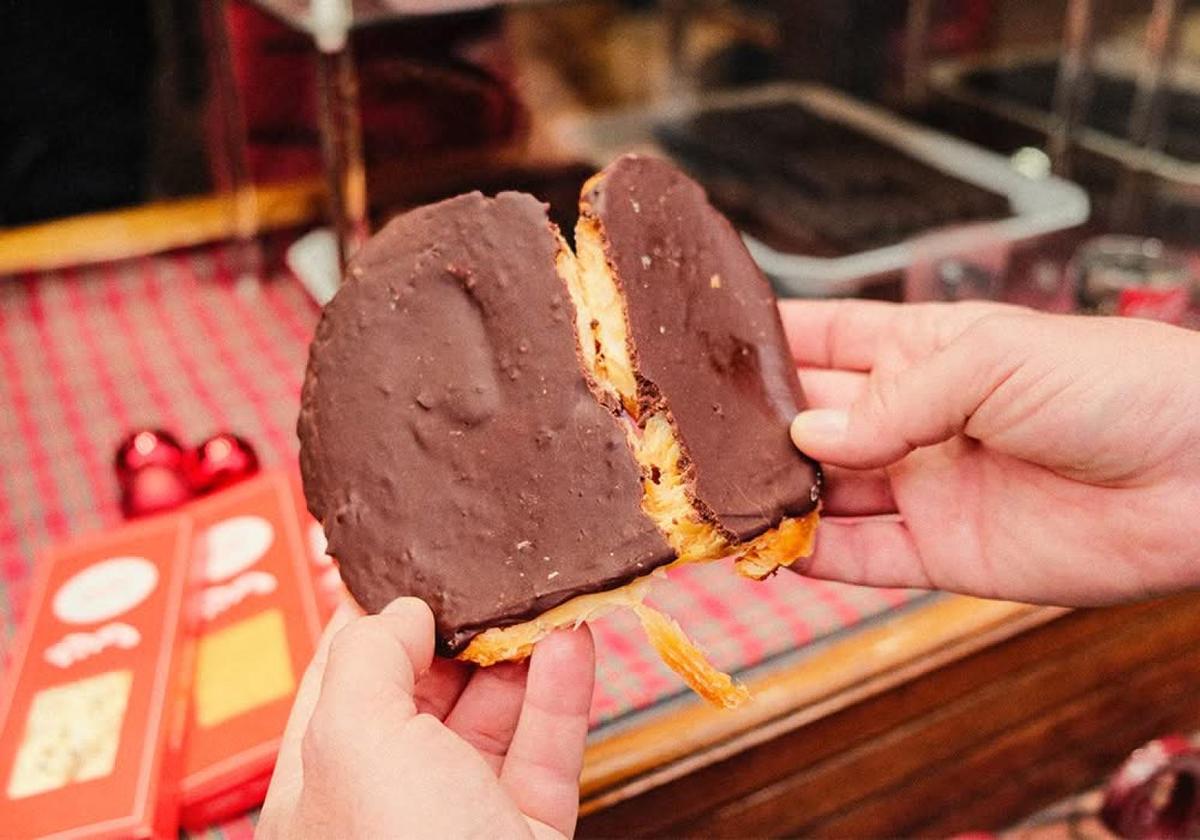 Hand holding a chocolate covered ice cream bar in Bilbao