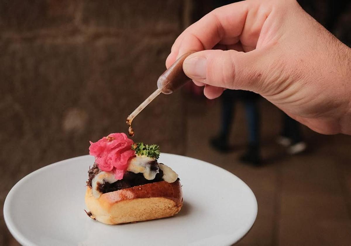 Hand placing garnish on a pintxo in Bilbao