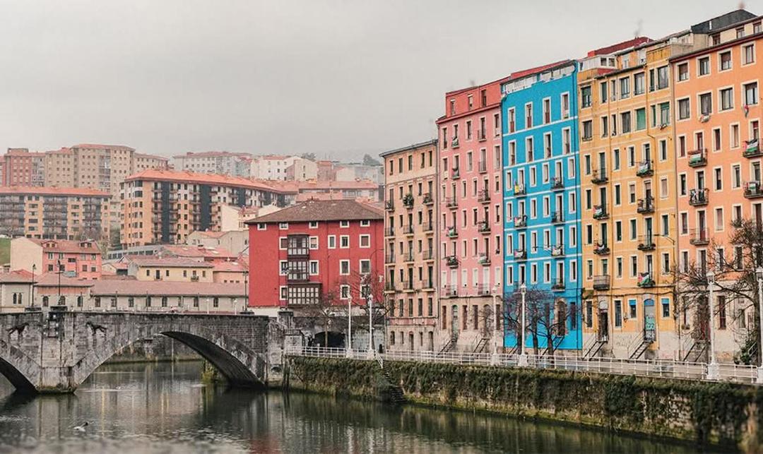 Colorful riverside buildings and bridge in Bilbao