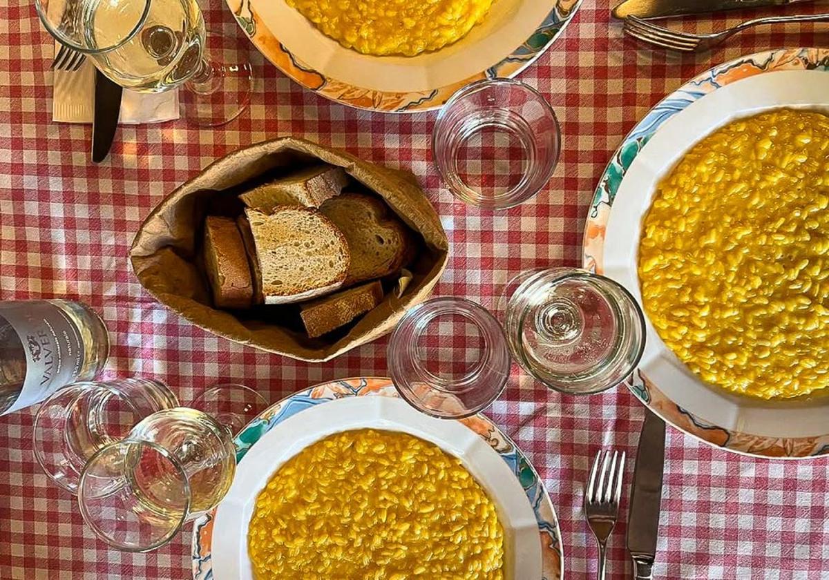 Saffron risotto and Milanese dishes served on a checkered tablecloth
