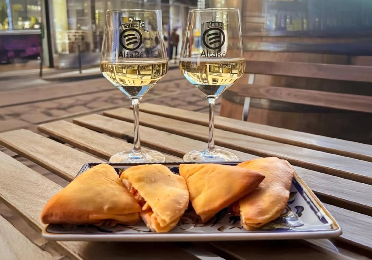 Panzerotti with wine served at an outdoor Milan café table