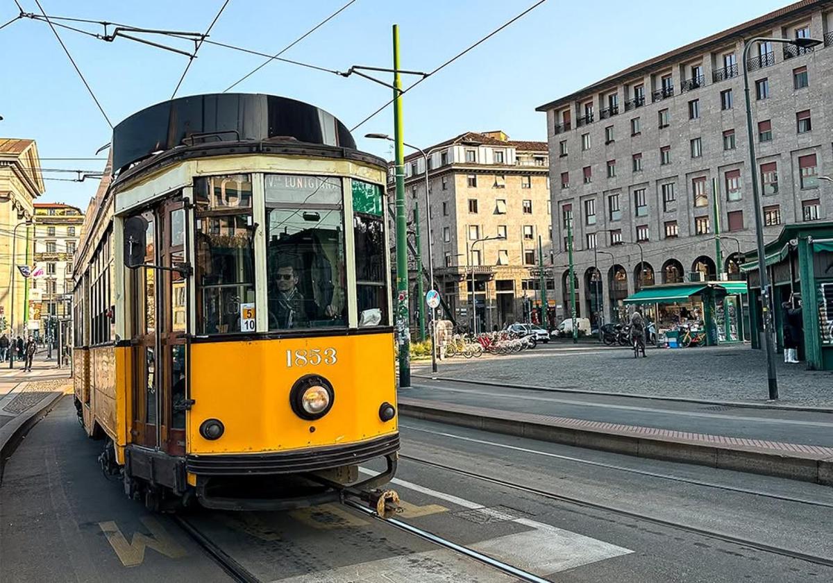 Yellow Milan tram passing through the city streets