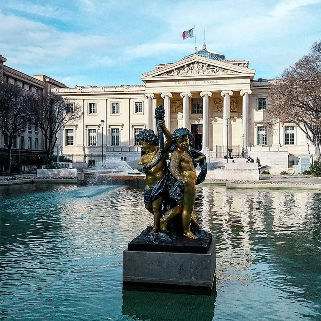 Palais de Justice in Marseille with fountain and statue in the foreground